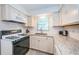 Corner kitchen with white cabinets and granite counters at 2511 Quincy S St, St Petersburg, FL 33711