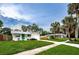 Ranch-style home on a tree-lined street with a fenced yard at 2511 Quincy S St, St Petersburg, FL 33711
