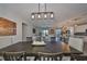 Open concept dining room with large wooden table, and view of living room at 3091 King Fern Dr, Wimauma, FL 33598