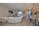 Living room with sectional sofa, large TV, and sliding doors to the pool at 3091 King Fern Dr, Wimauma, FL 33598