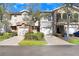 Front view of charming townhouses with attached garages and lush landscaping at 310 Summer Clouds Pl, Brandon, FL 33511