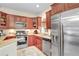 Modern kitchen featuring stainless steel appliances and ample wood cabinetry at 310 Summer Clouds Pl, Brandon, FL 33511