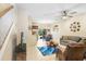 Open living room with leather furniture, TV, and view to kitchen at 310 Summer Clouds Pl, Brandon, FL 33511