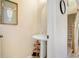 Small powder room with pedestal sink and round mirror at 310 Summer Clouds Pl, Brandon, FL 33511