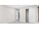 Simple bedroom with neutral walls, marble floors, and a closet at 316 Shore E Dr, Oldsmar, FL 34677