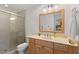 Clean bathroom with wood vanity, large mirror, and walk-in shower at 350 6Th N Ave, Tierra Verde, FL 33715