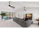Spacious living room with gray sectional sofa and large sliding glass doors at 350 6Th N Ave, Tierra Verde, FL 33715
