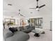 Open living area with gray sectional sofa, access to kitchen and pool views at 350 6Th N Ave, Tierra Verde, FL 33715
