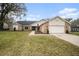 Brick and shingle home with landscaped lawn and attached garage at 3933 Northridge Dr, Valrico, FL 33596