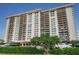 Front view of a high rise building with lush landscaping at 400 Island Way # 309, Clearwater Beach, FL 33767