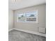 Bright bedroom featuring a large window with blinds at 4504 S Cameron Ave, Tampa, FL 33611