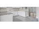 White kitchen cabinets, granite countertops, and tile floors at 4504 S Cameron Ave, Tampa, FL 33611