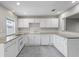 White kitchen with granite countertops and stainless steel appliances at 4504 S Cameron Ave, Tampa, FL 33611
