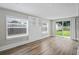 Spacious living room with hardwood floors, built-in shelving, and backyard access at 4504 S Cameron Ave, Tampa, FL 33611