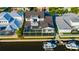 Aerial view of house near the water with a boat and a screened patio at 615 Mirabay Blvd, Apollo Beach, FL 33572