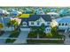 Aerial view of a two-story white farmhouse with surrounding houses and palm trees at 615 Mirabay Blvd, Apollo Beach, FL 33572