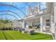 Large backyard with a hot tub and covered patio area at 615 Mirabay Blvd, Apollo Beach, FL 33572