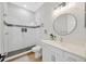 Modern bathroom with white subway tile shower and round mirror at 615 Mirabay Blvd, Apollo Beach, FL 33572