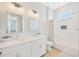 Bathroom with white cabinets, double vanity, and herringbone tile shower at 615 Mirabay Blvd, Apollo Beach, FL 33572
