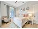 Bright bedroom with a queen bed, sitting chair, and access to the backyard at 615 Mirabay Blvd, Apollo Beach, FL 33572