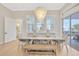 Bright dining room features a large table, bench, and chandelier at 615 Mirabay Blvd, Apollo Beach, FL 33572