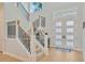 Bright entryway with a grand staircase and double doors at 615 Mirabay Blvd, Apollo Beach, FL 33572