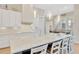 White kitchen with a large island and pendant lighting at 615 Mirabay Blvd, Apollo Beach, FL 33572