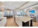 Kitchen with white cabinets, a large island, and stainless steel appliances at 615 Mirabay Blvd, Apollo Beach, FL 33572