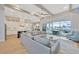 Open living room and kitchen with exposed beams, a fireplace, and water views at 615 Mirabay Blvd, Apollo Beach, FL 33572