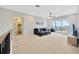Open living area with sectional sofa, balcony access, and adjacent bathroom at 615 Mirabay Blvd, Apollo Beach, FL 33572