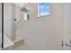 Spa-like shower with rainfall showerhead and pebble tile floor at 615 Mirabay Blvd, Apollo Beach, FL 33572