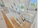 Elegant two-story entry with a grand chandelier and a modern staircase at 615 Mirabay Blvd, Apollo Beach, FL 33572