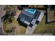 Aerial view of a property with a private pool, dark roof, and a carport at 6254 Pershing Ne St, St Petersburg, FL 33702