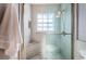 Elegant bathroom featuring a glass-enclosed shower with a built-in seat for comfort and convenience at 6254 Pershing Ne St, St Petersburg, FL 33702