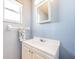 Charming bathroom featuring a white vanity with an oval sink and natural lighting at 6254 Pershing Ne St, St Petersburg, FL 33702