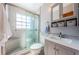 Stylish bathroom with a glass-enclosed shower and marble tiling, providing a modern and luxurious experience at 6254 Pershing Ne St, St Petersburg, FL 33702