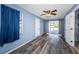 Bedroom featuring wood floors, a ceiling fan, access to the bathroom, and an exit to the patio at 6254 Pershing Ne St, St Petersburg, FL 33702
