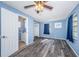 Comfortable bedroom featuring a ceiling fan, wood floors, ensuite bathroom, and closet at 6254 Pershing Ne St, St Petersburg, FL 33702