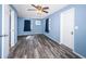 Bedroom with blue walls, wood floors, a ceiling fan, and a light window at 6254 Pershing Ne St, St Petersburg, FL 33702
