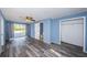 Bedroom featuring wood floors, a ceiling fan, access to the bathroom, and a closet at 6254 Pershing Ne St, St Petersburg, FL 33702