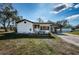 Inviting single-story home showcasing a covered front porch and a connected carport for convenient parking at 6254 Pershing Ne St, St Petersburg, FL 33702