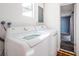 Laundry room with a modern washing machine and dryer set and a window, offering convenience for laundry tasks at 6254 Pershing Ne St, St Petersburg, FL 33702