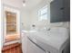 Laundry room with a modern washing machine and dryer set and a window, offering convenience for laundry tasks at 6254 Pershing Ne St, St Petersburg, FL 33702