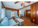 The charming living room features wood paneling, comfortable seating, and a view into the dining room at 6254 Pershing Ne St, St Petersburg, FL 33702