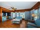 A cozy living room features wood paneling, a ceiling fan, and comfortable seating at 6254 Pershing Ne St, St Petersburg, FL 33702