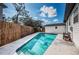 A backyard pool that is surrounded by a privacy fence and features a deck area for lounging at 6254 Pershing Ne St, St Petersburg, FL 33702