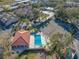 Aerial view of the community pool, tennis courts, and lush tropical landscaping at 6262 142Nd N Ave # 603, Clearwater, FL 33760