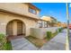 Inviting condo exterior showcasing the arched entryways, neutral color palette, and landscaping at 6262 142Nd N Ave # 603, Clearwater, FL 33760