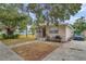 Tan block house with brown door, small front yard, and driveway at 652 13Th S Ave, St Petersburg, FL 33701