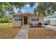 Tan block house with brown door, small front yard, and driveway at 652 13Th S Ave, St Petersburg, FL 33701